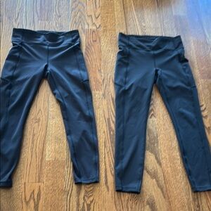 Two pair of Lululemon Invigorate black leggings with side pockets
